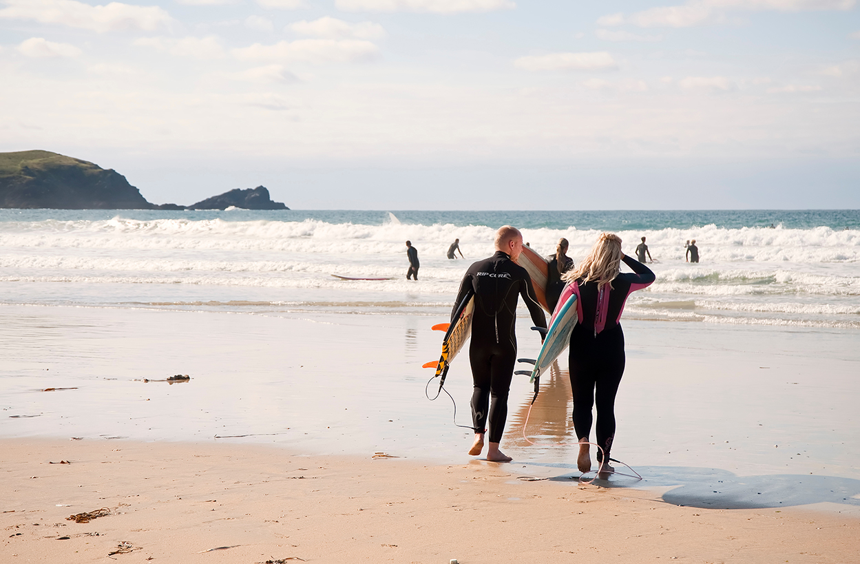 Surfers going into the water at Fistral Beach